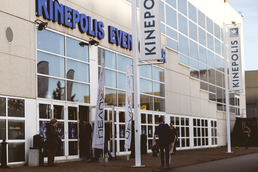 The Kinepolis Event Centre frontage by day: glass facade, tall KINEPOLIS signage and banners at the doors.